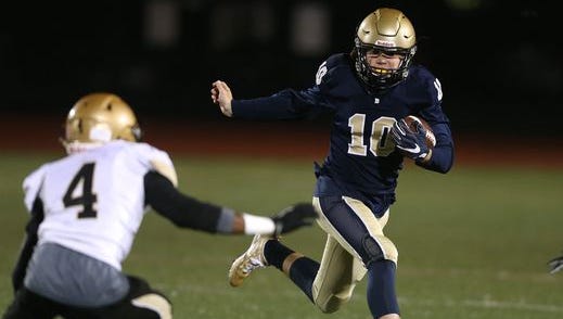 Brighton quarterback Shea McDonald, shown here trying to elude Greece Athena safety Kenny Speed (4), helped the Barons win the team's first Monroe County division title since 1999.