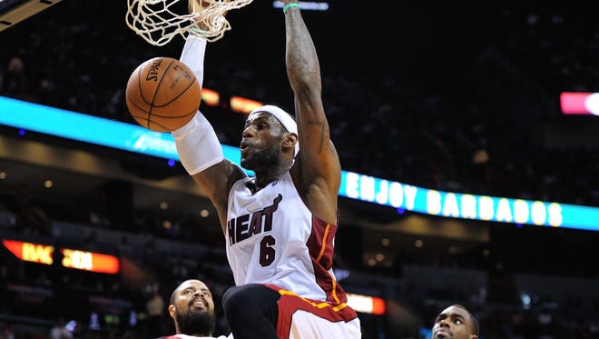 Miami’s LeBron James dunks the ball Sunday against the New York Knicks.