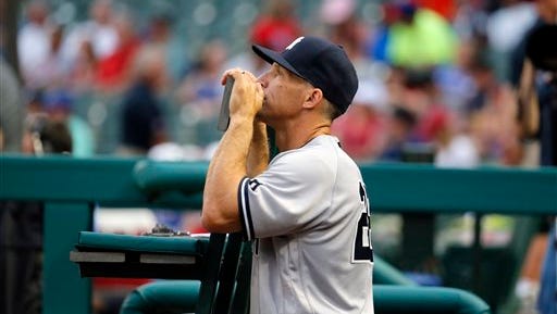 New York Yankees manager Joe Girardi stands in the dugout before the start of the first inning of a baseball game against the New York Yankees on Tuesday, April 26, 2016, in Arlington, Texas.