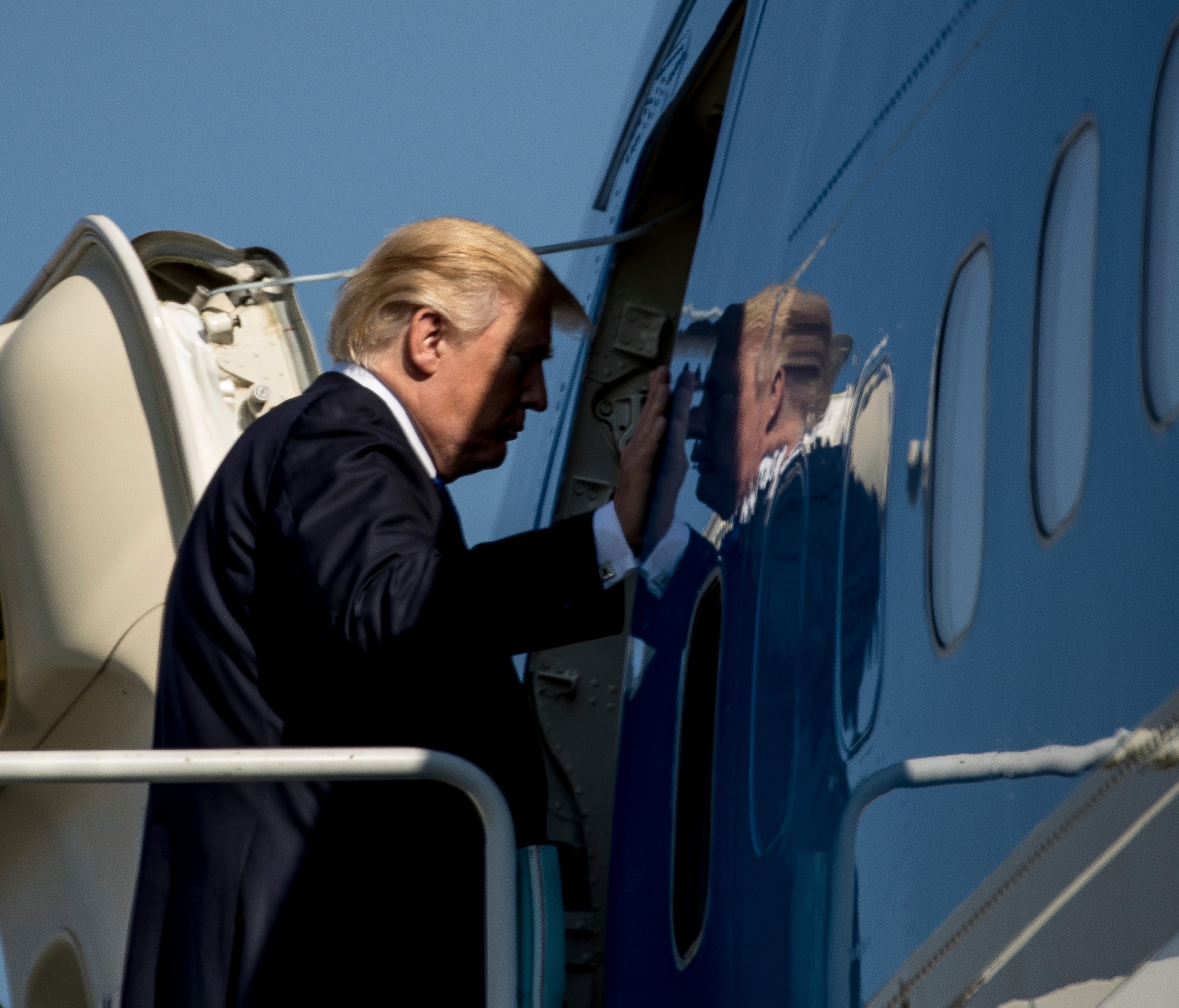 President Trump boards Air Force One in Japan.