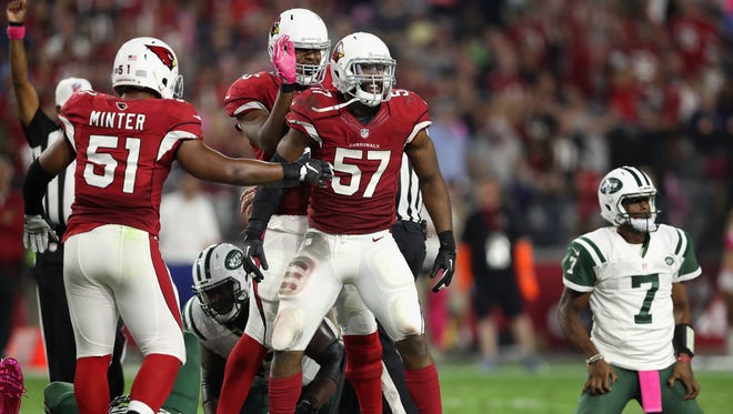 Outside linebacker Alex Okafor #57 of the Arizona Cardinals celebrates with Kevin Minter #51 after a sack on quarterback Geno Smith #7 of the New York Jets during the fourth quarter of Monday's game at the University of Phoenix Stadium on October 17, 2016 in Glendale, Arizona.