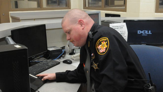Deputy Tony Helterbridle talks to inmates on the intercom Monday at the Ross County Jail and the Chillicothe-Ross County Law Enforcement Complex. The intercom system is one of the possible repairs and upgrades being looked at for the building.