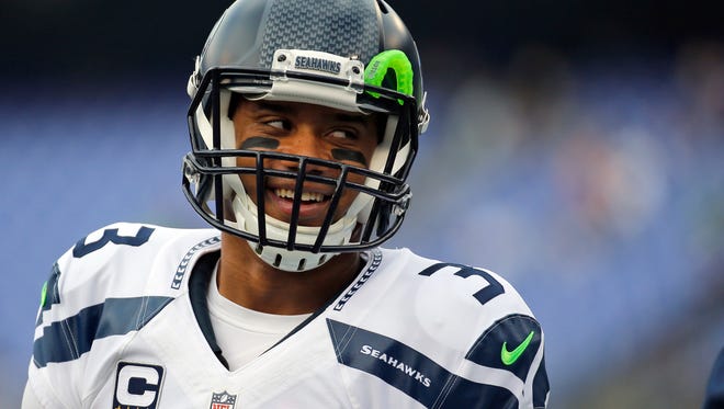 FILE - In this Dec. 13, 2015, file photo, Seattle Seahawks quarterback Russell Wilson (3) smiles during warms up before an NFL football game against the Baltimore Ravens, in Baltimore. Russell Wilson has it all put together. Johnny Manziel has been nothing but chaos since entering the NFL. The two players with similar football skills meet for the first time on Sunday.(AP Photo/Patrick Semansky, File)