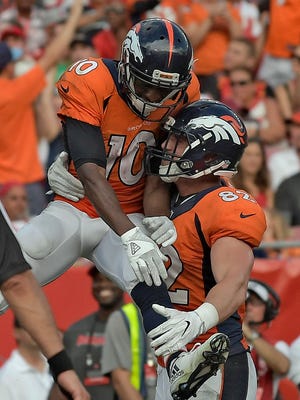 Denver Broncos wide receiver Emmanuel Sanders (10) celebrates with tight end Jeff Heuerman (82) after Sanders caught a 5-yrd touchdown pass against the Tampa Bay Buccaneers during the fourth quarter of an NFL football game Sunday, Oct. 2, 2016, in Tampa, Fla. (AP Photo/Phelan Ebenhack) 