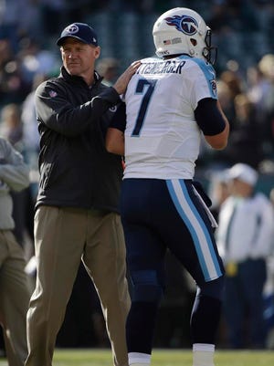 Titans coach Ken Whisenhunt greets quarterback Zach Mettenberger before their game against the Eagles.