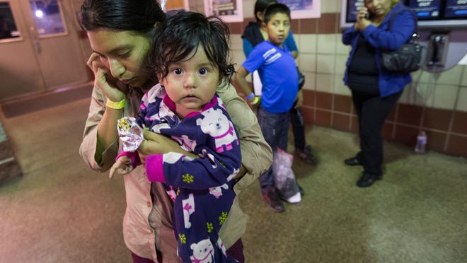 Guatemala national Judy Eliza- beth Martinez holds baby Mar- jorie and calls family after being released by ICE at a Phoenix bus station. 
Michael Chow/the Republic Judy Elizabeth Martinez, holding Marjorie, tries to reach family after being released by ICE at a Greyhound Bus station in Phoenix May 28, 2014. She is from Guatemala and was flown from Georgia to Arizona by ICE. The Border Patrol says about 400 migrants were flown from Texas to Arizona because of surge in migrants being apprehended in Texas.