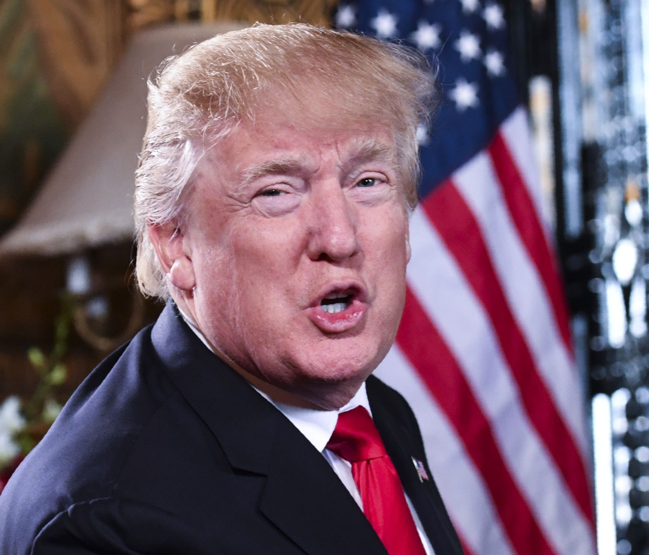 President Trump speaks to the media before participating in a video teleconference calls with military members in Palm Beach, Fla., Dec. 24, 2017.