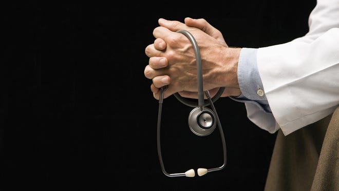 File: Hands with stethoscope