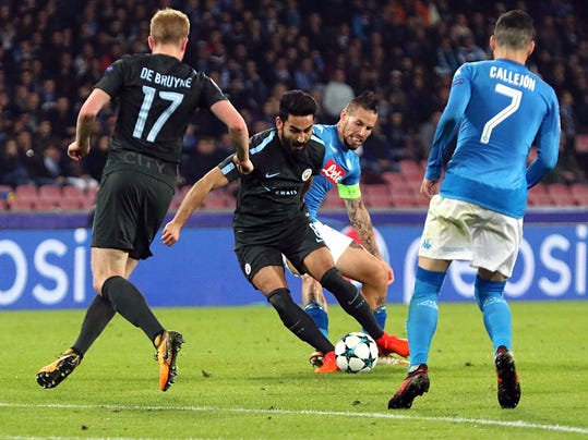 Manchester City's Ilkay Gundogan, center, is challenged by Napoli's Marek Hamsik during the Champions League Group F soccer match between Napoli and Manchester City, at the San Paolo stadium in Naples, Italy, Wednesday, Nov. 1, 2017. (Cesare Abbate/ANSA via AP)