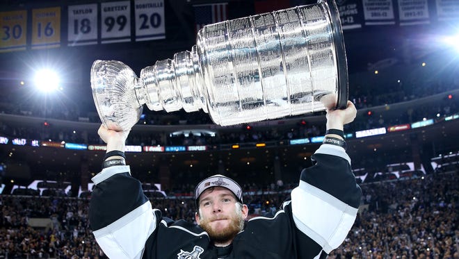 Goaltender Jonathan Quick celebrates with the Stanley Cup on June 13 after the Los Angeles Kings beat the New York Rangers in double overtime to clinch the series in five games.