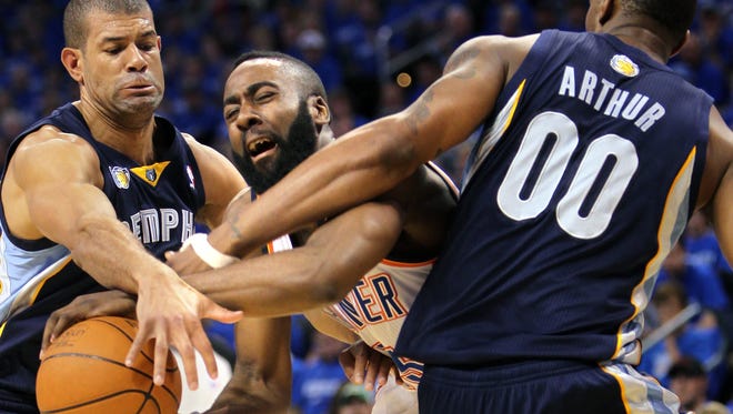 Oklahoma City Thunder guard James Harden (13) gets his pocket picked by Memphis Grizzlies forward Shane Battier (31) and Memphis Grizzlies forward Darrell Arthur (00) during the first game of the second round in Oklahoma City on May 1, 2011.