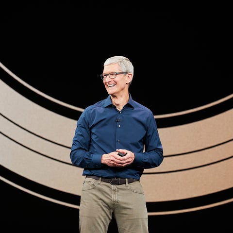 Apple CEO Tim Cook smiling and standing on a stage