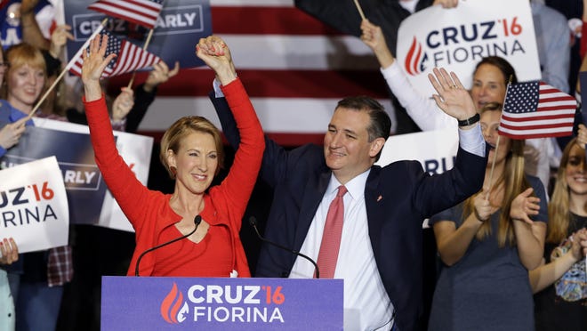 Republican presidential candidate Sen. Ted Cruz, R-Texas, joined by former Hewlett-Packard CEO Carly Fiorina, waves during a rally in Indianapolis, Wednesday, April 27, 2016, when Cruz announced he has chosen Fiorina to serve as his running mate. (AP Photo/Michael Conroy)