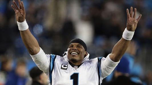 Carolina Panthers quarterback Cam Newton celebrates on the sideline during the fourth quarter of the NFC Championship Game against the Arizona Cardinals.