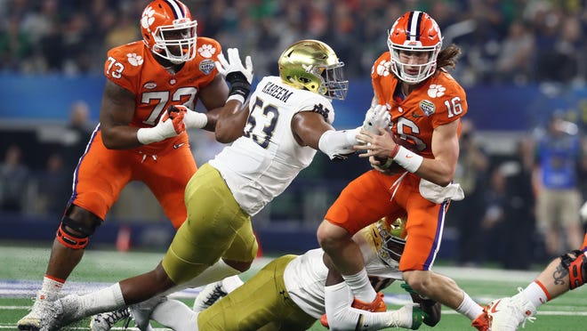 Dec 29, 2018; Arlington, TX, United States; Clemson Tigers quarterback Trevor Lawrence (16) tries to run away from Notre Dame Fighting Irish defensive lineman Khalid Kareem (53)  in the first half in the 2018 Cotton Bowl college football playoff semifinal game at AT&amp;T Stadium. Mandatory Credit: Matthew Emmons-USA TODAY Sports