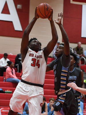 Greenville's J.Q. Jones (34) drives to the basket against Daniel during the Red Raiders' 56-41 win Tuesday night at Slick Moore Gymnasium.