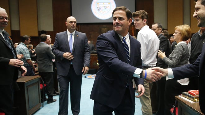 Arizona Gov. Doug Ducey shakes hands after giving his State of the State speech at the Capitol in Phoenix on Jan. 8, 2018.