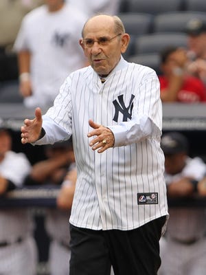 Yogi Berra enters the field for a ceremony to honor Roger Maris at a 2011 game at Yankee Stadium.