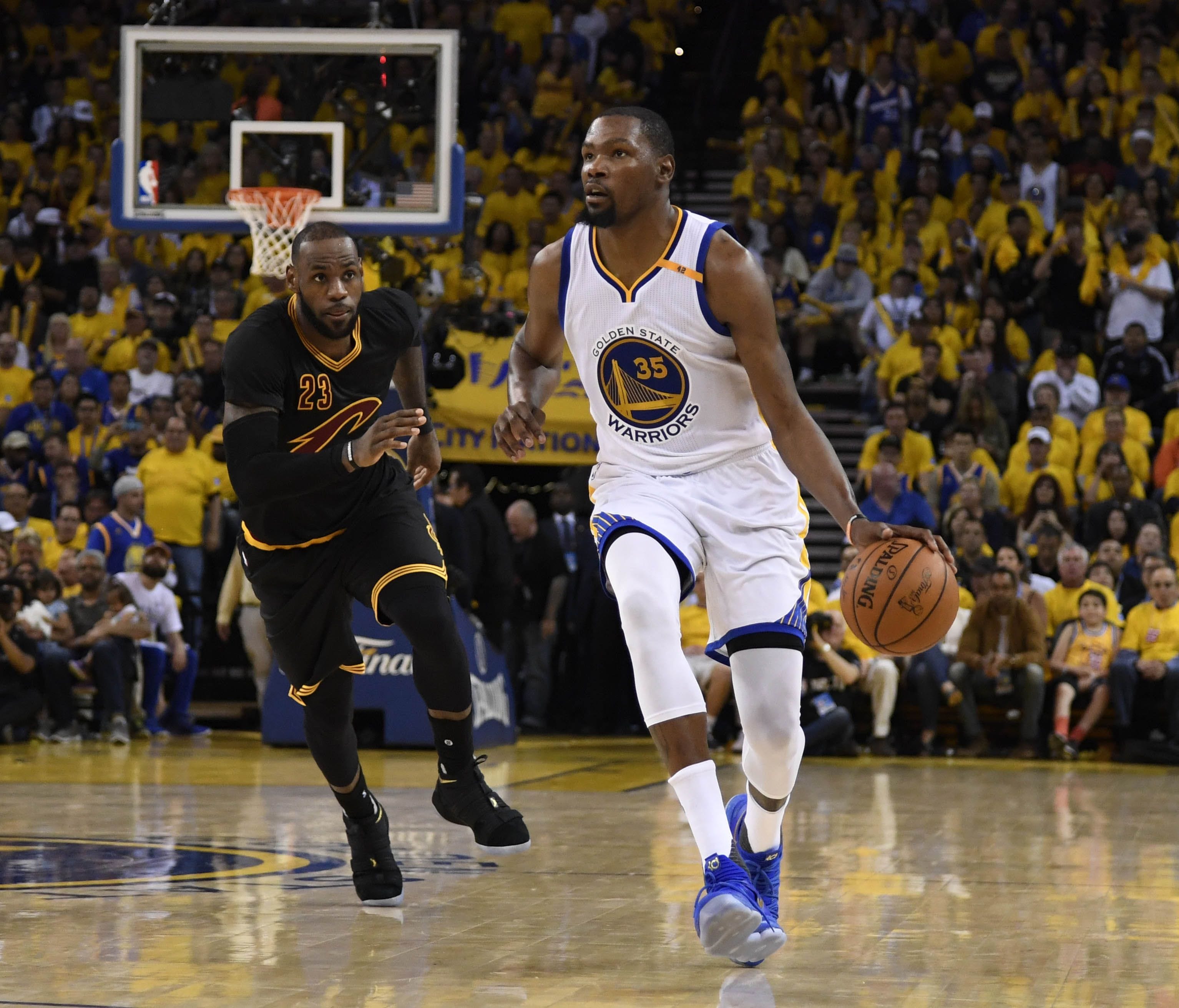 Golden State Warriors forward Kevin Durant (35) dribbles the ball past Cleveland Cavaliers forward LeBron James (23) during the second half in game two of the 2017 NBA Finals at Oracle Arena.