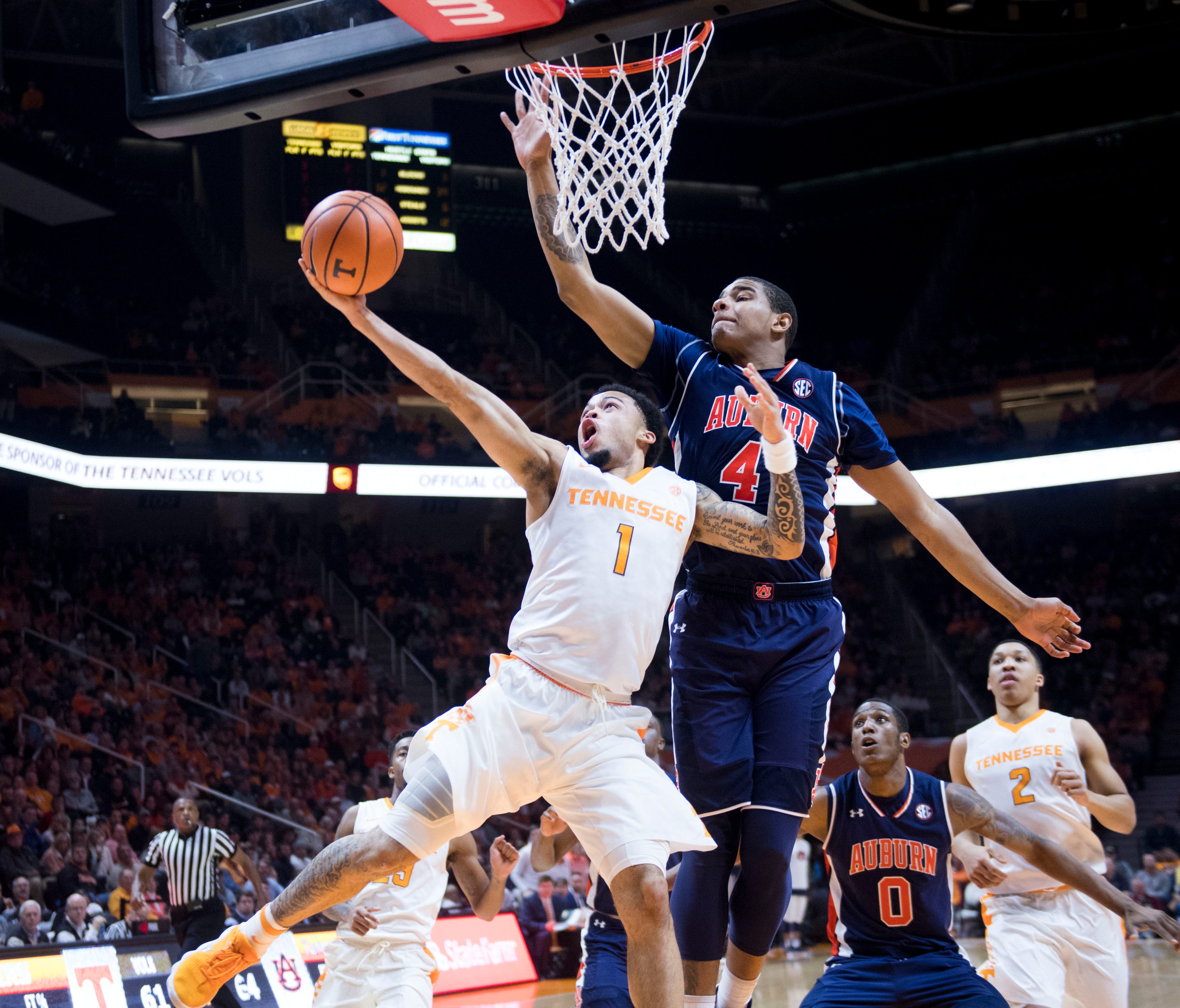 Tennessee's Lamonté Turner attempts to score while defended by Auburn's Chuma Okeke.