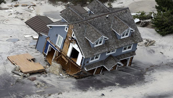 This aerial photo shows a collapsed house along the central Jersey Shore coast on Wednesday, Oct. 31, 2012. New Jersey got the brunt of Sandy, which made landfall in the state and killed six people. More than 2 million customers were without power as of Wednesday afternoon, down from a peak of 2.7 million.