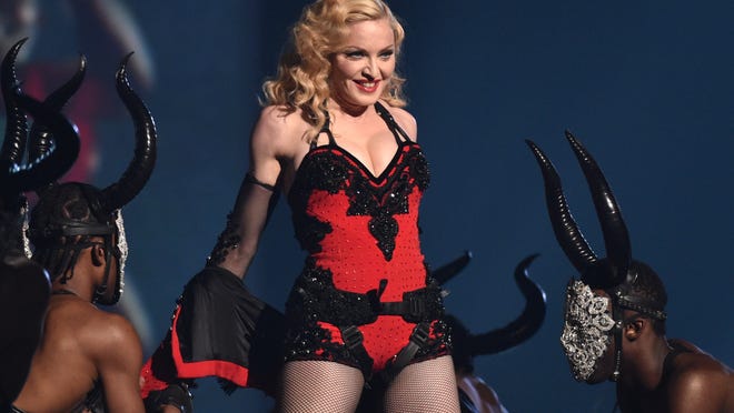 Madonna, performing at the 57th annual Grammy Awards in Los Angeles, has been criticized for remarks panning her hometown.