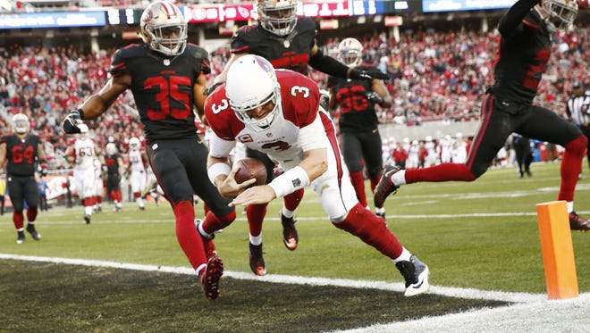 Arizona Cardinals quarterback Carson Palmer takes the ball himself and runs for the winning touchdown against the San Francisco 49ers in the second half on Nov. 29, 2015 in Santa Clara, Calif.