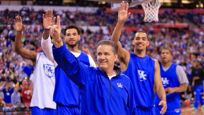 Kentucky head coach John Calipari and players wave to fans at the end of practice Friday afternoon at Lucas Oil Stadium. By Matt Stone, The C-J April 3, 2015.