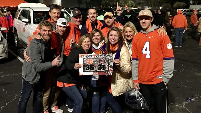 A group of Clemson fans including Jay and Mandy Hall celebrate the Tigers' first national championship in football in 35 years after beating Alabama 35-31 on Monday.