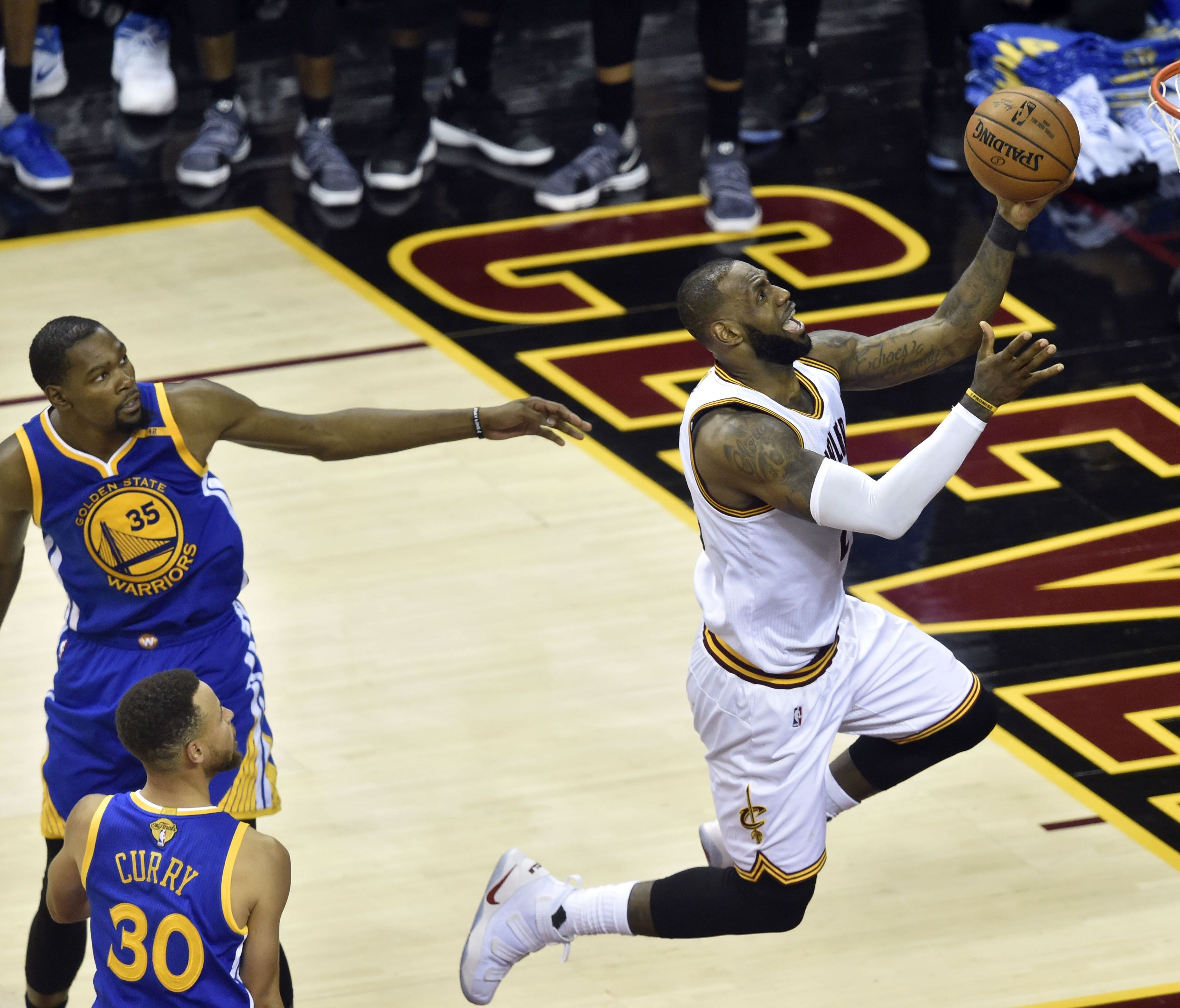 Cleveland Cavaliers forward LeBron James (23) shoots the ball against Golden State Warriors forward Kevin Durant (35) during the fourth quarter in game three of the 2017 NBA Finals at Quicken Loans Arena.