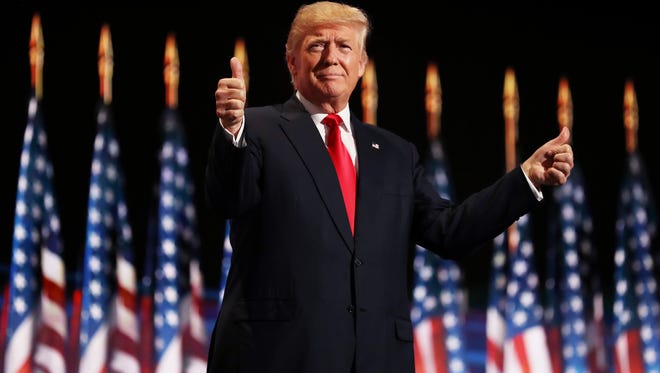 Republican presidential candidate Donald Trump gives two thumbs up to the crowd during the evening session on the fourth day of the Republican National Convention on July 21, 2016, at the Quicken Loans Arena in Cleveland, Ohio.