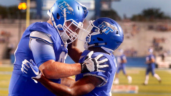 MTSU's Ty Lee, right, celebrates his touchdown with Ty Watkins (85) in the first half against Bowling Green on Saturday, Sept. 23, 2017.