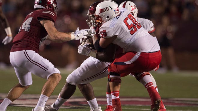 Troy defensive tackle Jamal Stadom (30) is tackle day South Alabama offensive lineman Zach Davis (50) during the Troy  vs South University  NCAA football game on Wednesday, Oct. 11, 2017, in Troy, Ala. 