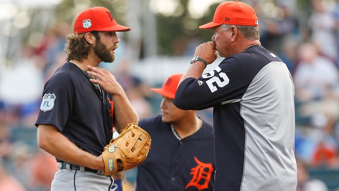 Tigers pitching coach Rich Dubee (52) talks with pitcher Daniel Norris (44) during the third inning Monday in Lake Buena Vista, Fla.
