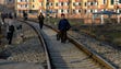 People walk on a rail tracks in Pyongyang, April 18,