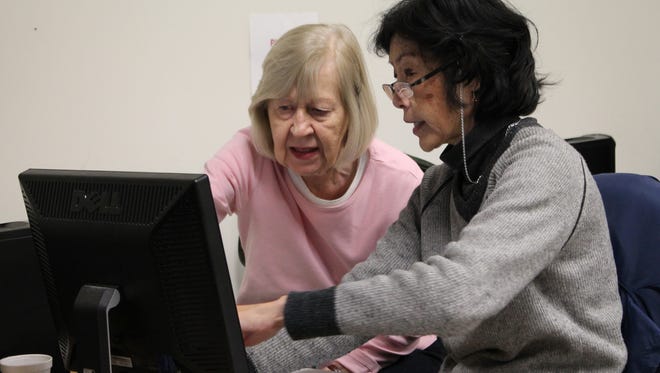 Juliana Lord, a counselor with the Michigan Medicare/Medicaid Assistance Program, helps Troy resident Ethel Simmons size up her Medicare options.