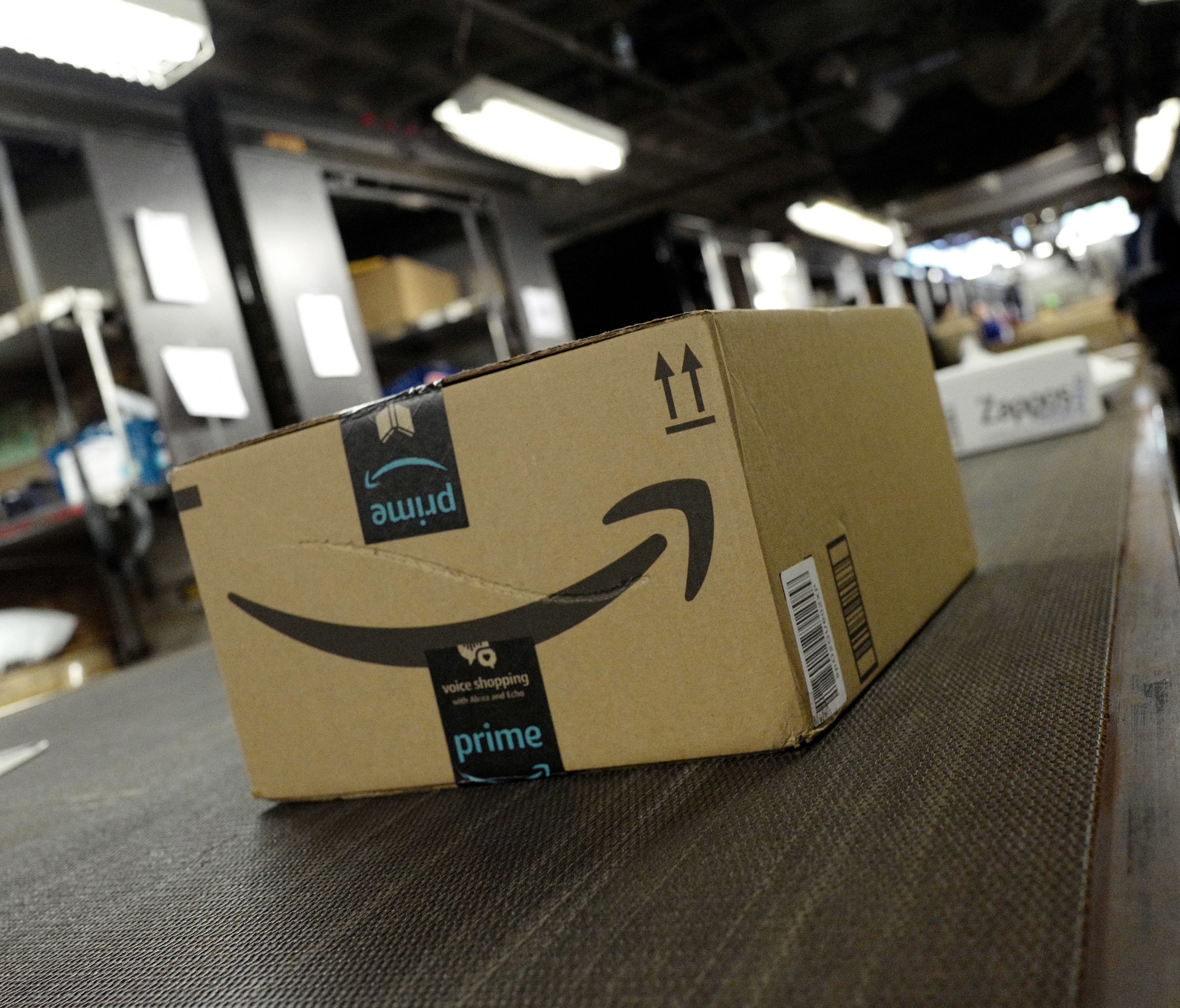 In this Tuesday, May 9, 2017, photo, a package from Amazon Prime moves on a conveyor belt at a UPS facility in New York. Online shoppers will pay close attention to at least two things this holiday season: shipping costs and return deadlines. (AP Pho