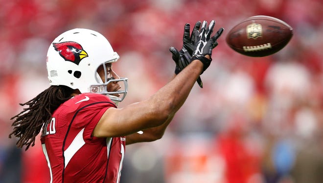Cardinals wide receiver Larry Fitzgerald catches a pass during pregame warmups against the Kansas City Chiefs on Sunday, Dec. 7, 2014 at University of Phoenix Stadium in Glendale, AZ.