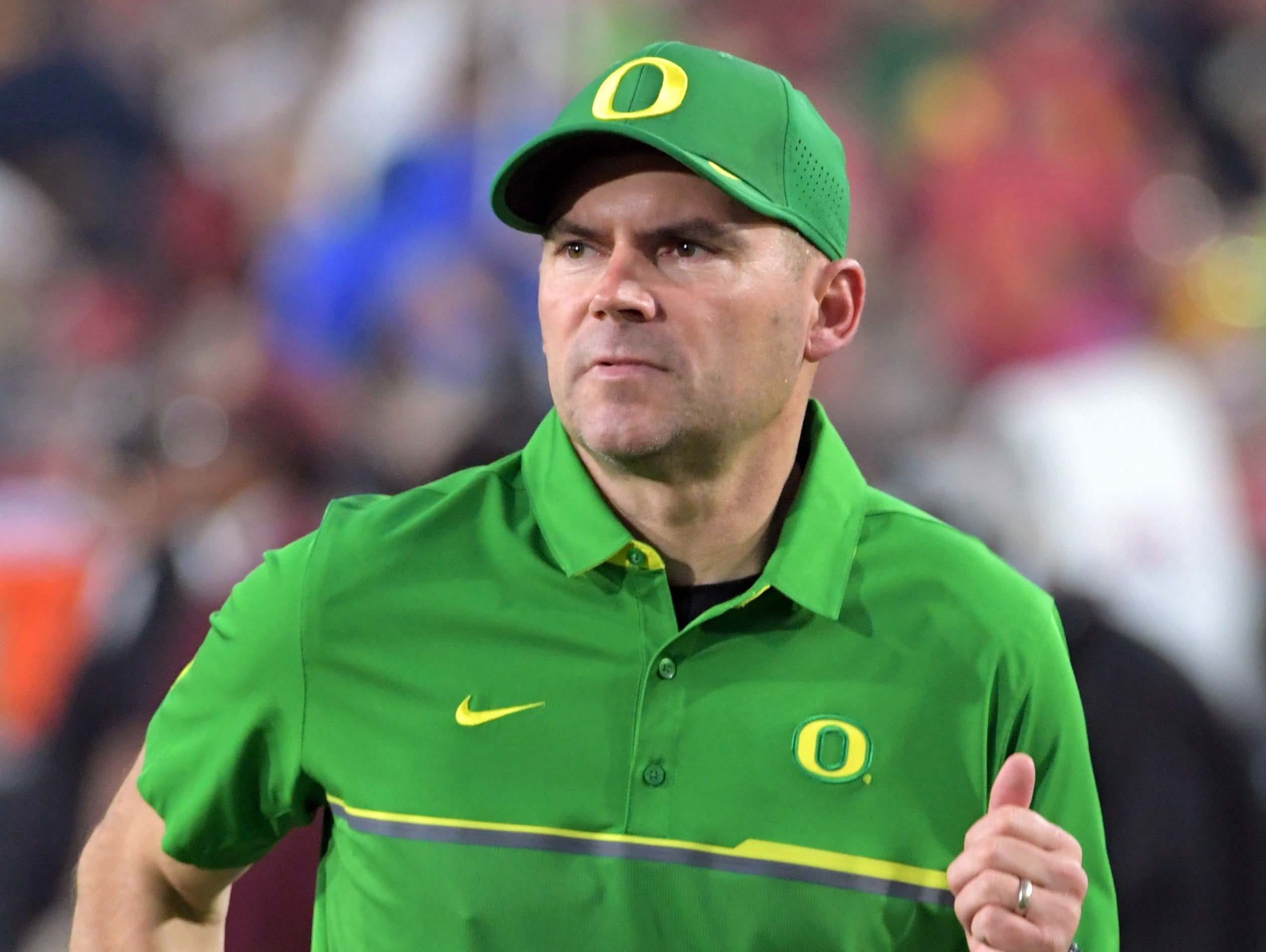 Oregon Ducks head coach Mark Helfrich enters the field before a NCAA football game against the Southern California Trojans at Los Angeles Memorial Coliseum.