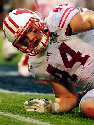 A file photo from Jan 1, 2014 of Wisconsin linebacker Chris Borland (44) getting up from a tackle in the Capital One Bowl. Borland, 24, abruptly retired after a promising rookie season in the NFL, citing concern over the long-term consequences of head trauma.