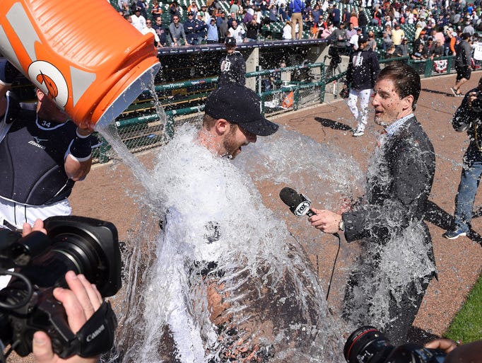 Tigers' James McCann, left, dumps icy water on Andrew