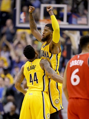 Indiana Pacers forward Paul George (13) celebrates with Jeff Teague (44) late in the second half of their game Tuesday, April 4, 2016, evening at Bankers Life Fieldhouse. The Indiana Pacers defeated the Toronto Raptors 108-90.