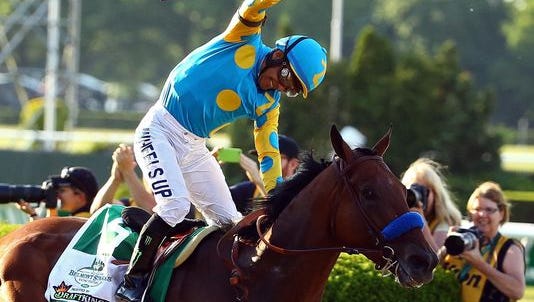 Victor Espinoza celebrates atop American Pharoah after winning the 147th running of the Belmont Stakes at Belmont Park on Saturday in Elmont, New York. With the win, American Pharoah becomes the first horse to win the Triple Crown in 37 years.