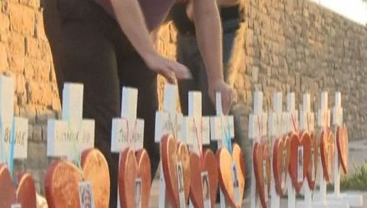 Twelve crosses were set up Sunday night at the corner of Alameda and Sable in memory of the 12 people killed in the Aurora theater shooting three years ago Monday.