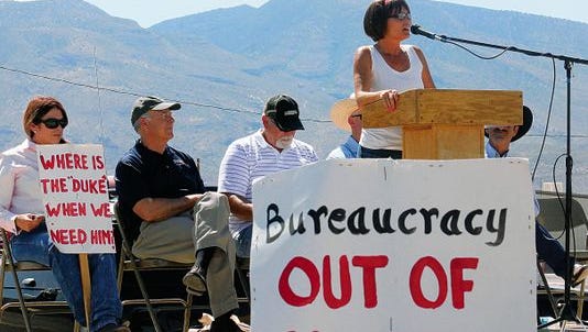 In this May 31, 2014 file photo, state Rep. Yvette Herrell talks about private property rights, states rights and the federal government over stepping its control of the Lincoln National Forest. Congressman Steve Pearce and Otero County Commissioner Ronny Rardin are seated behind Herrell.