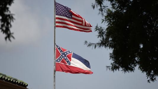 The American flag and the Mississippi state flag fly in downtown Jackson.