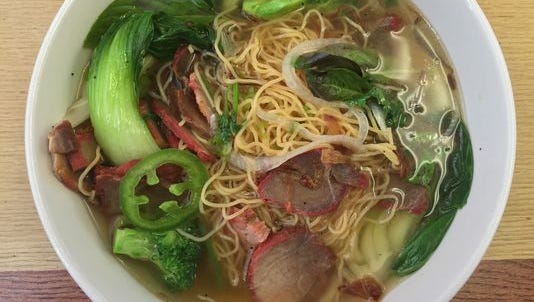 Barbecue pork and egg noodle soup is one of several such noodle soups served at Asian Noodles. Basil, green chiles and lime for juicing accompany the soup, to be added at will.