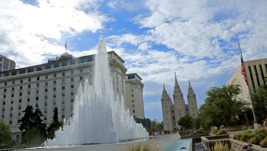 Members of The Church of Jesus Christ of Latter-day Saints walk through Temple Square in Salt Lake City following the afternoon session of the faith’s General Conference last year.