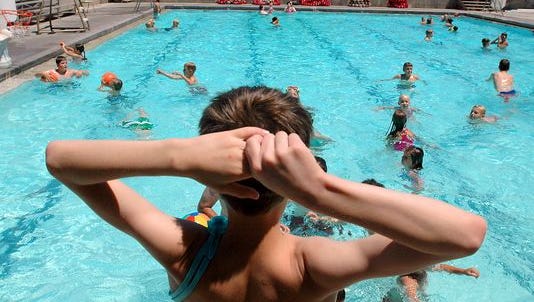 A boy prepares to jump into the pool on a hot day in Cedar City in this file photo.