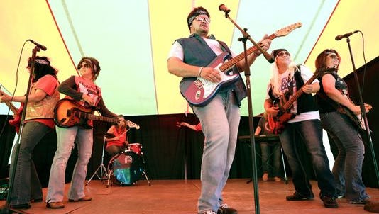 Andy Booher, center, a policy support representative with SECURA Insurance Co., performs a talent show act with fellow employees during the United Way Fox Cities Community Kickoff event Aug. 26, 2015, at SECURA Insurance Co., in Appleton.
